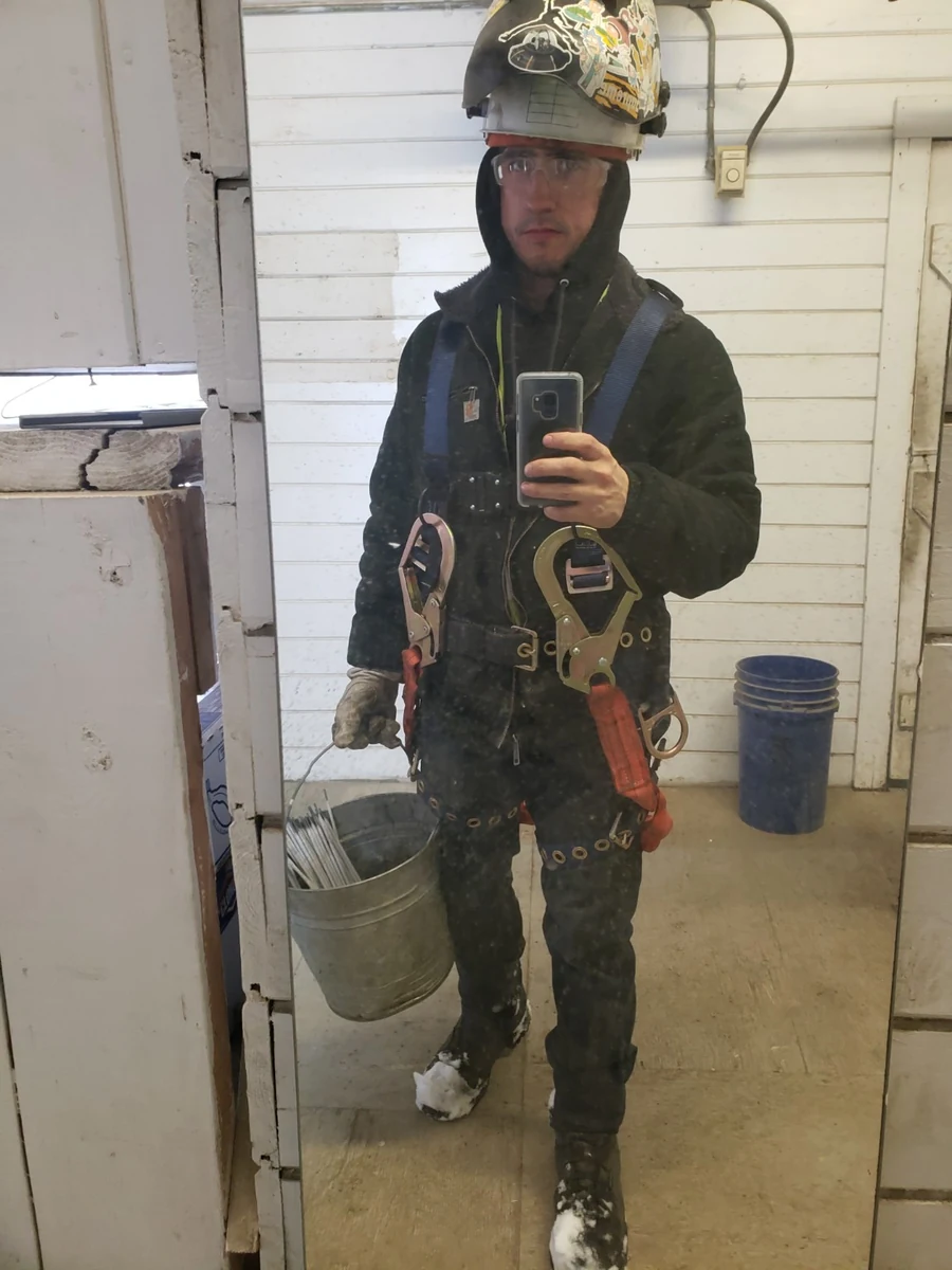 Taylor in winter jobsite gear and a safety harness